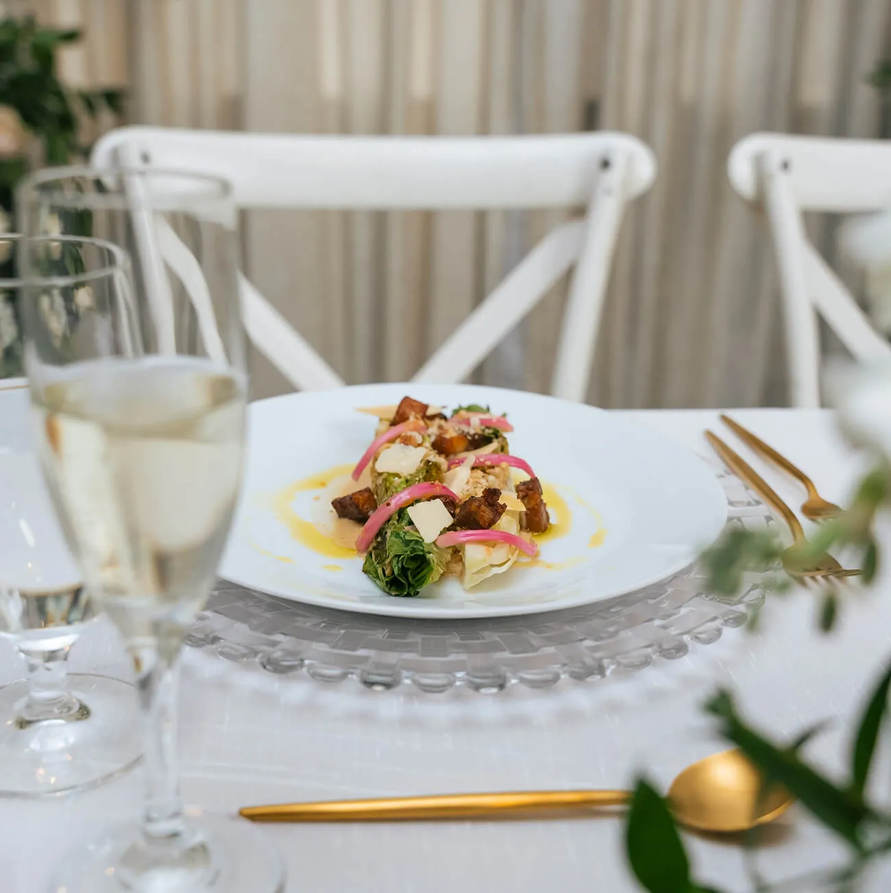 Gourmet grilled romaine salad with pickled onions served at a formal dinner