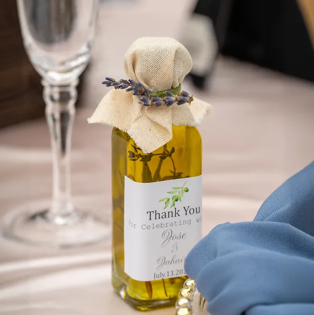 Personalized olive oil wedding favor on a reception table